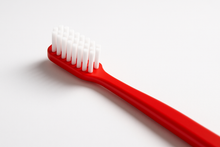 Load image into Gallery viewer, A red tooth brush